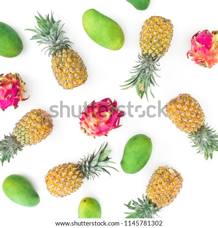 Pineapple, mango and dragon fruit on white background. Flat lay, top view. Food background.