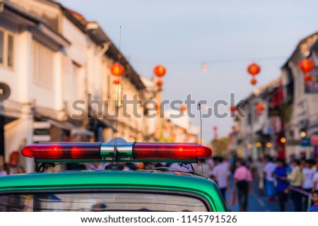 police flashing light, on the background of the Chinese new year celebration on the street . patrol during the holiday, in the afternoon