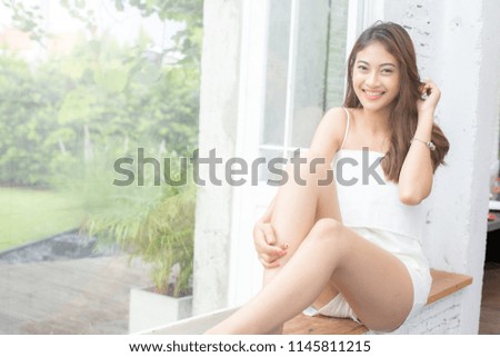 Young beautiful asian woman looking to camera with attractive smiling at home. People lifestyle concept.