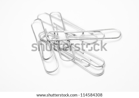 Close up of isolated metal paper clips Royalty-Free Stock Photo #114584308