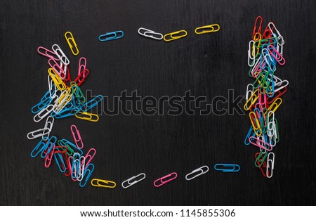 Multicolored paper clips on a dark background