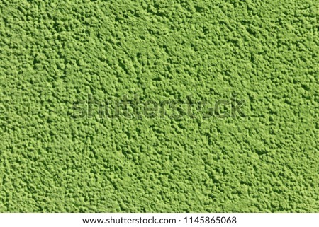 Decorative green plaster texture on the wall. Texture of the green stucco wall for background