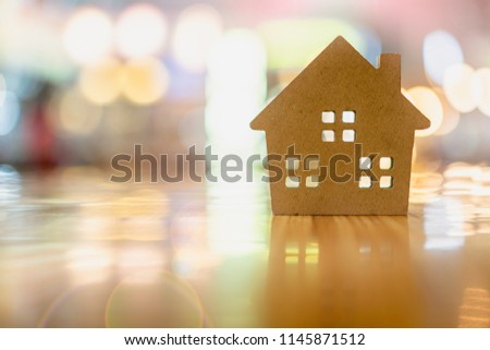 Wood house model on  wood background, a symbol for construction , ecology, loan, mortgage, property or home.