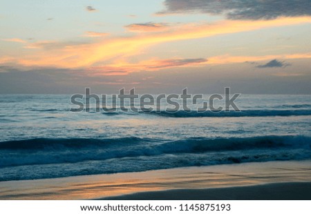 Amazing sunset on Karon beach. The surf pounds the shore. Phuket, Thailand