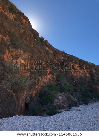 Sun about to rise over bottom of the cliff at the Mandu Mandu Gorge, Exmouth, Western Australia