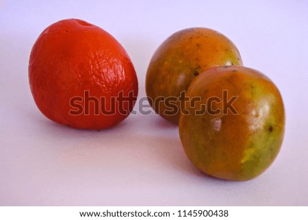 old tomatoes are striking red color and young tomatoes are yellow-green