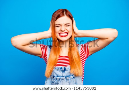 Omg it's too much! Close up photo portrait of sad upset unhappy unsatisfied aggressive girl closing ears with palms isolated bright background