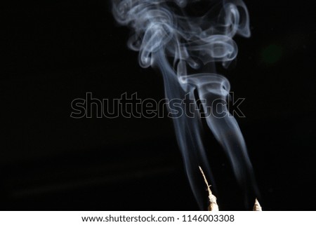smoke joss stick on black background isolated