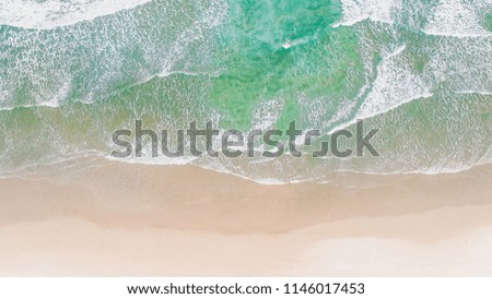 Wave Beach Aerial, Beach on aerial drone top view with ocean waves reaching shore, top view aerial photo from flying drone of an amazingly beautiful sea landscape. Ocean Wallpaper. 