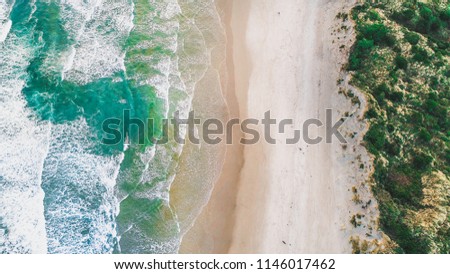 Wave Beach Aerial, Beach on aerial drone top view with ocean waves reaching shore, top view aerial photo from flying drone of an amazingly beautiful sea landscape. Ocean Wallpaper. 
