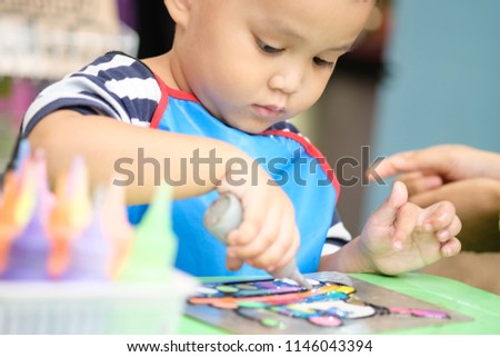 cute small kid painting with acrylic colors on paper