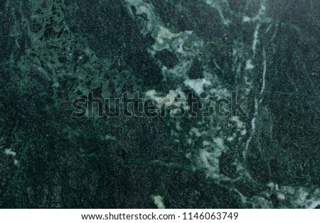 Green marble surface close up texture. Malachite deep green natural color texture. Detailed close up background of malachite gemstone in high resolution