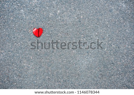 Red heart on the asphalt from above