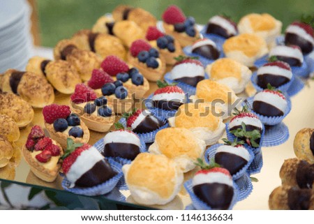 Assorted pastries on mirrored tray, close-up