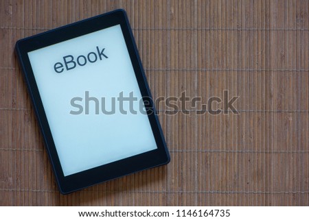A black e-reader with white screen and text ebook Royalty-Free Stock Photo #1146164735