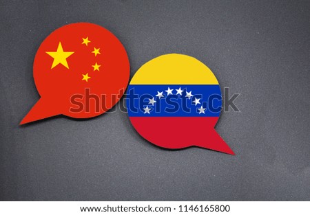 China and Venezuela flags with two speech bubbles on dark gray background