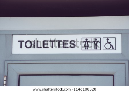 French public toilet door with the French word „Toilettes“ and toilet symbols