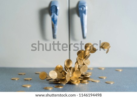 Falling gold coins money on office table with document cabinet background, business money and finance concept idea.