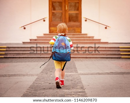 Happy smiling kid in glasses is going to school for the first time. Child boy with bag go to elementary school. Child of primary school. Pupil go study with backpack. Back to school Royalty-Free Stock Photo #1146209870