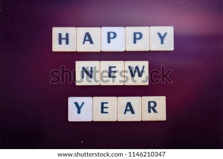 Happy New Year word formed by letter pieces