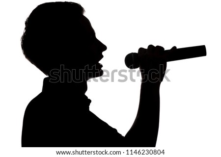 Silhouette of a young talented young man siinging into a microphon on white isolated background, boy face profile, concept hobby