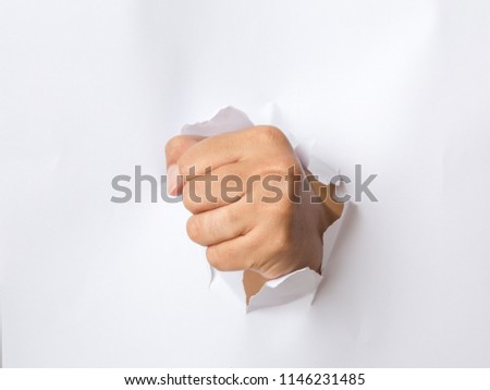 hand punching through the paper