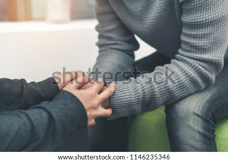 PTSD Mental health concept, Psychologist sitting and touch hand young depressed asian man for encouragement near window, Selective focus. Royalty-Free Stock Photo #1146235346