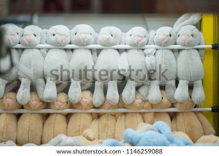 The fur toys in the toy catching machine in the supermarket