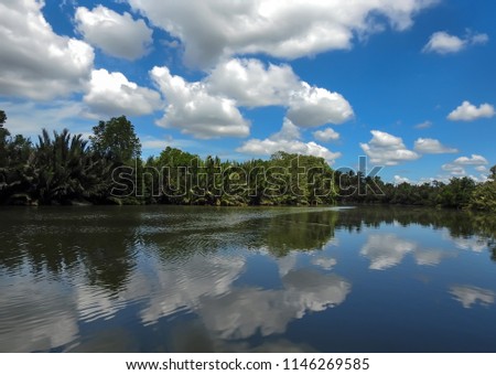  countryside view, Spring summer landscape with calm lake water and blue sky clouds . located at Terengganu, Malaysia.         
