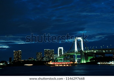 Photo of the night skyline over the river next to the Japanese bridge
