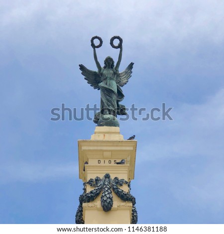 SAN SALVADOR, EL SALVADOR -  July 29, 2018: Square photo of the 1911 monument to the Heroes (Monumento a los Próceres) in Liberty Square (Plaza Libertad), depicting an angel with two laurel wreaths. Royalty-Free Stock Photo #1146381188