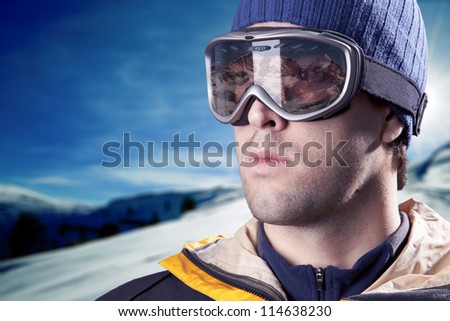 skier looking at the mountains with snowy mountains in the background.