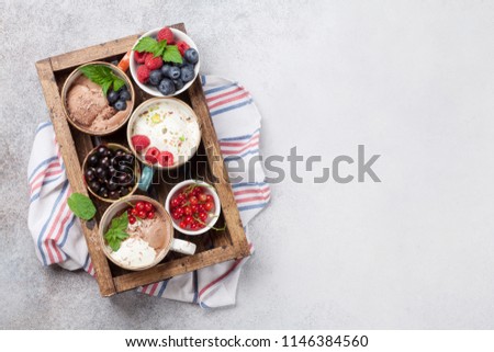 Ice cream with berries in wooden box. Top view with space for your text