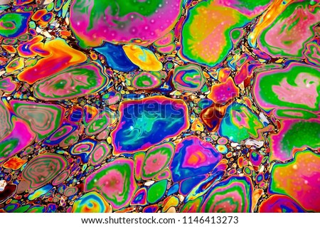 abstract image of multi-colored oil and gasoline stains on the water. psychedelic background or texture