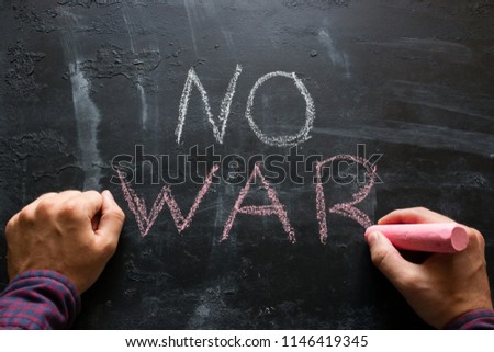 man writes the text "no war"