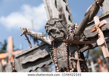 Old wooden crucifix of Christ at the Hill of Crosses in Siauliai, Lithuania. Hill of Crosses is a unique monument of history and religious folk art