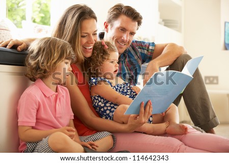 Parents Sitting With Children Reading Story Indoors Royalty-Free Stock Photo #114642343