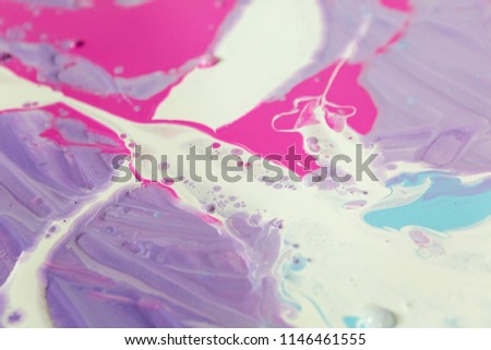 abstraction of the flowing multi-colored acrylic paints
