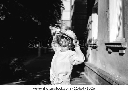 Pretty woman in white vintage dress walking on the street
