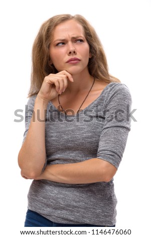 Young pretty thinking woman looking away, hand near face. Isolated on white background