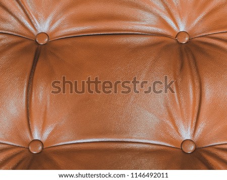 part of the leather sofa with wrinkles and button. Copy space 