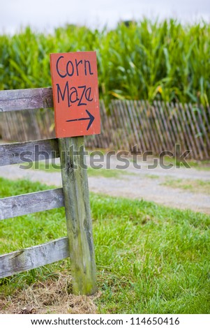 Orange corn maze sign with directional arrow