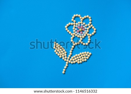 Assorted pharmaceutical medicine pills, tablets and capsules and bottle on purple background. Drugs and various narcotic substances. Copy space for text. Stock photo for design