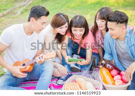 people use phone happily and enjoy go on a picnic