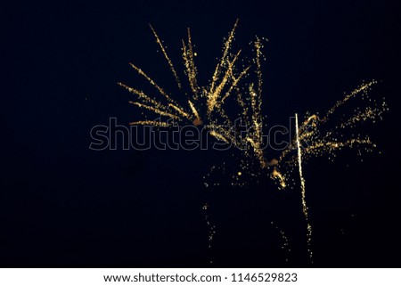 Golden fireworks in the sky. Festive golden exploding pyrotechnics