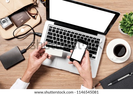 Man using credit card with mobile phone and laptop and coffee cup on office desk.Online payment Concept.