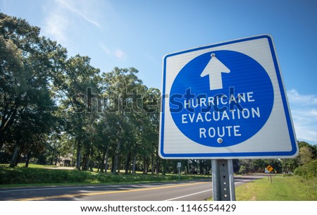 A sign directs hurricane evacuees to safety. Royalty-Free Stock Photo #1146554429