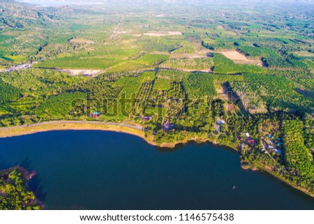 Dam with island green mountain forest blue water aerial view