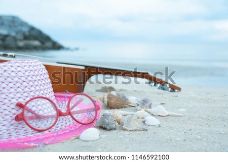 Ukulele Hat and Red Glasses
Placed on the sandy beach. The shells are located nearby.