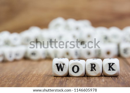 Wood dice with word WORK on dice.